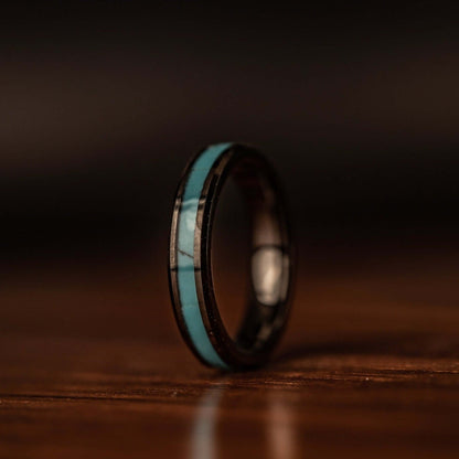 Stunning turquoise and black wedding ring duo, perfect for your special day.