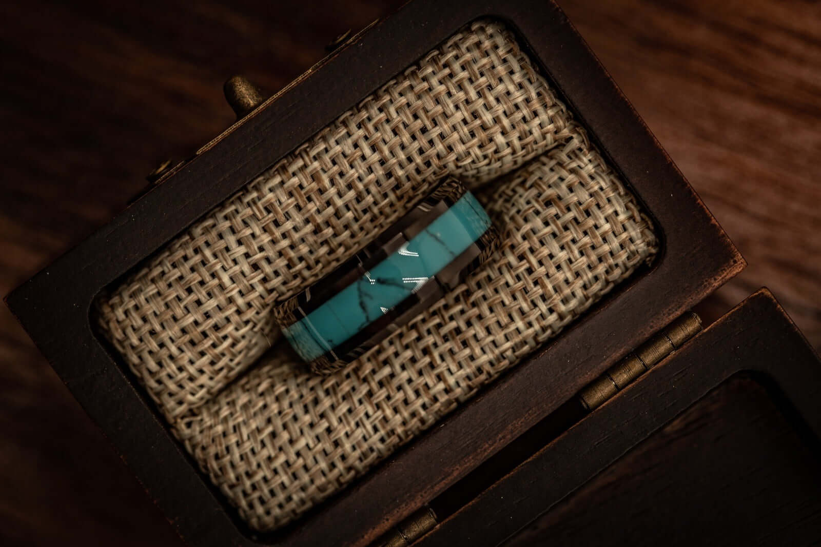 His and hers wedding rings in turquoise and black, crafted for lasting commitment.