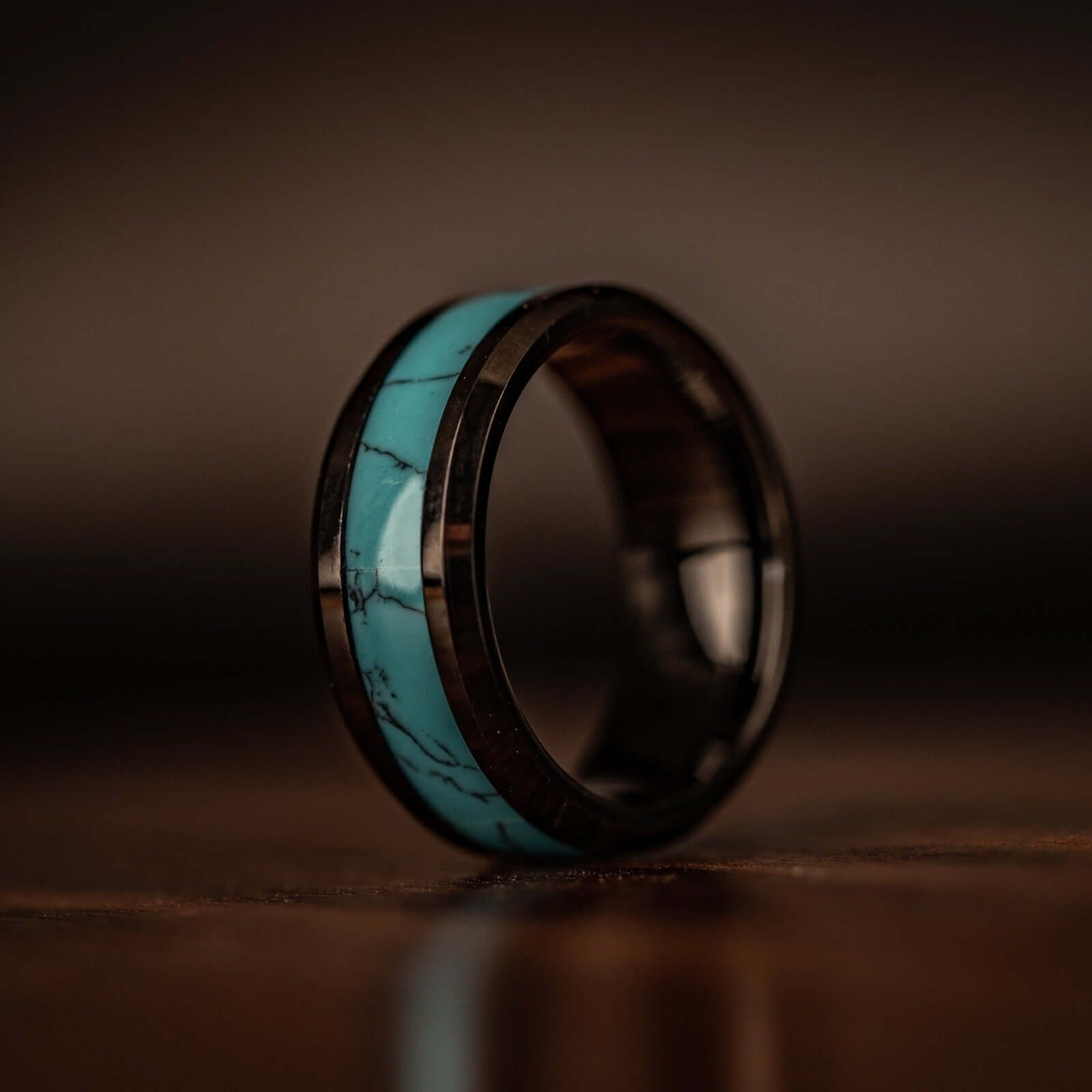 Turquoise and black engagement rings, symbolizing a lifetime of love and partnership.