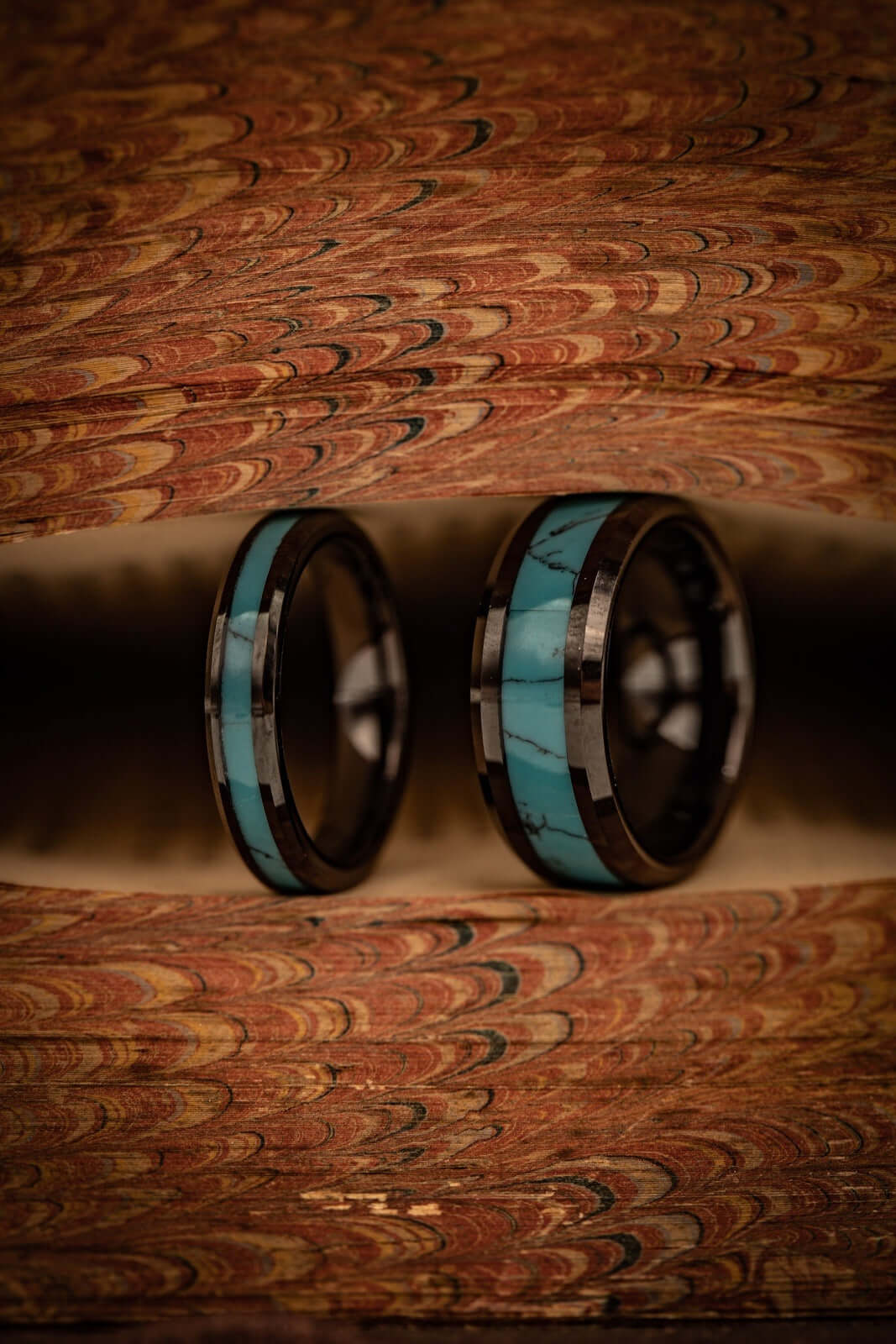 Vibrant turquoise and bold black wedding bands, perfect for your unique love story.