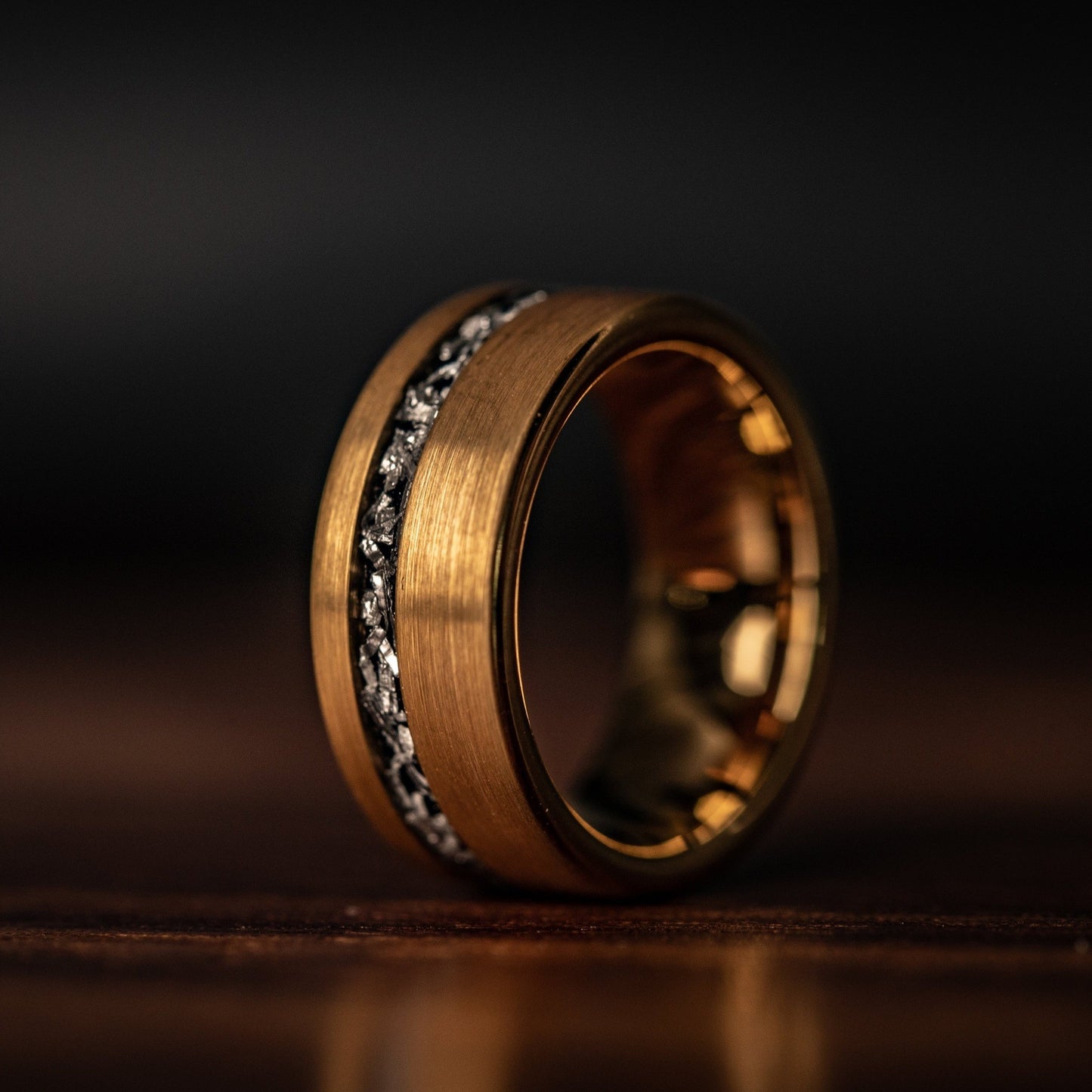 His and hers wedding bands with luxurious yellow gold and real meteorite detailing.