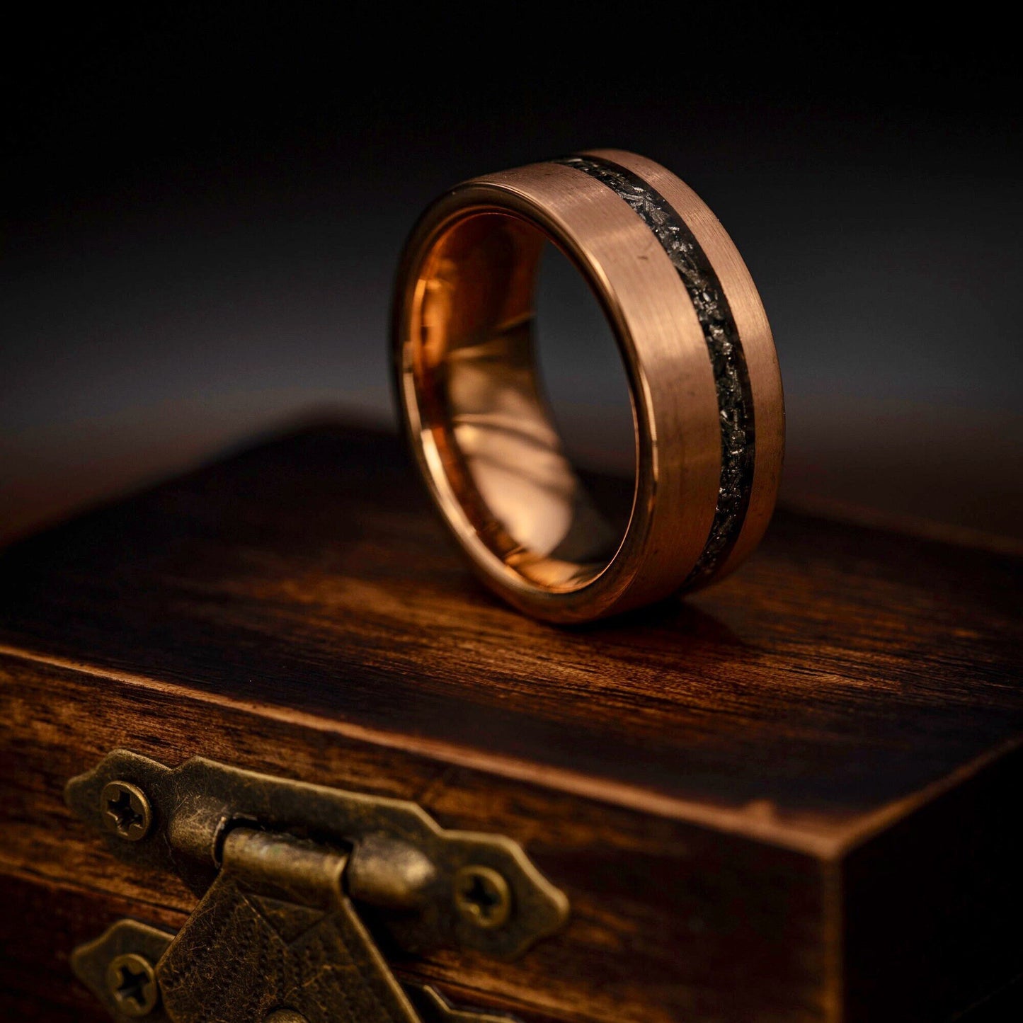Stylish men's wedding ring crafted from rose gold with real meteorite detailing.