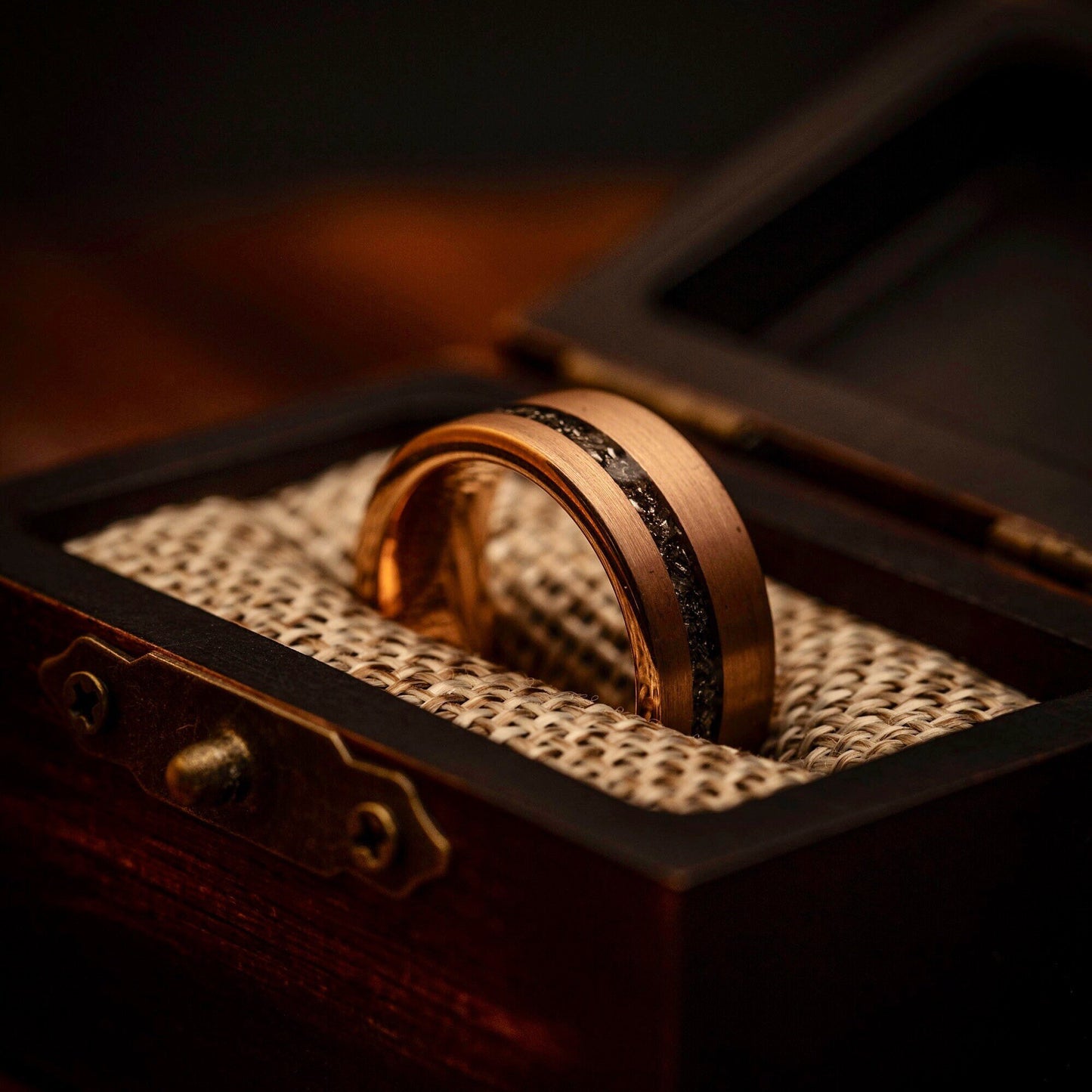 Distinctive rose gold wedding ring with genuine meteorite inlay, symbolizing eternal love.