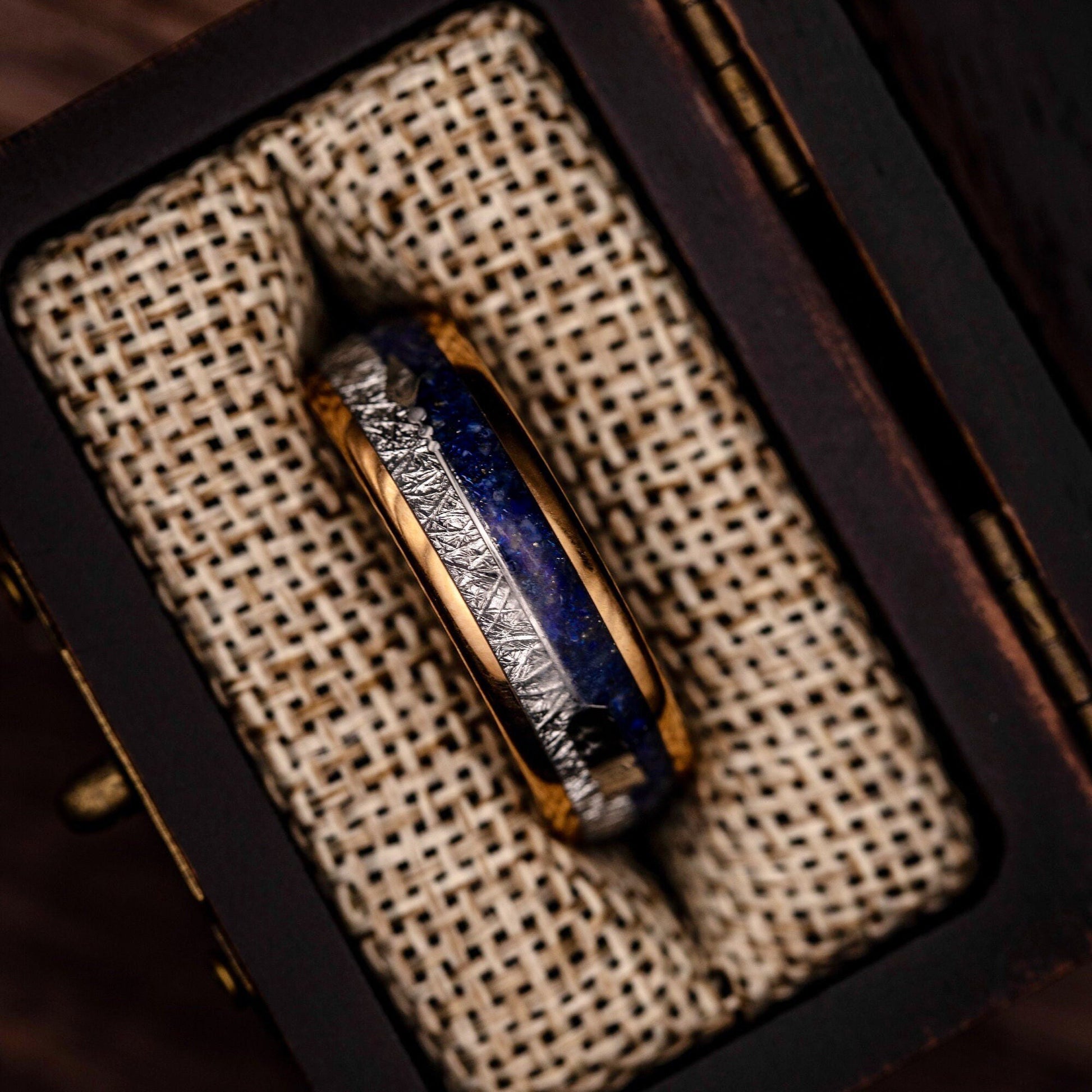 Sophisticated rose gold wedding band adorned with lapis lazuli and meteorite.