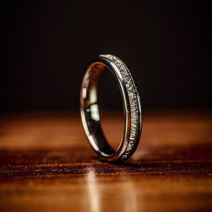 Women's silver wedding band featuring real meteorite, a unique choice for weddings.