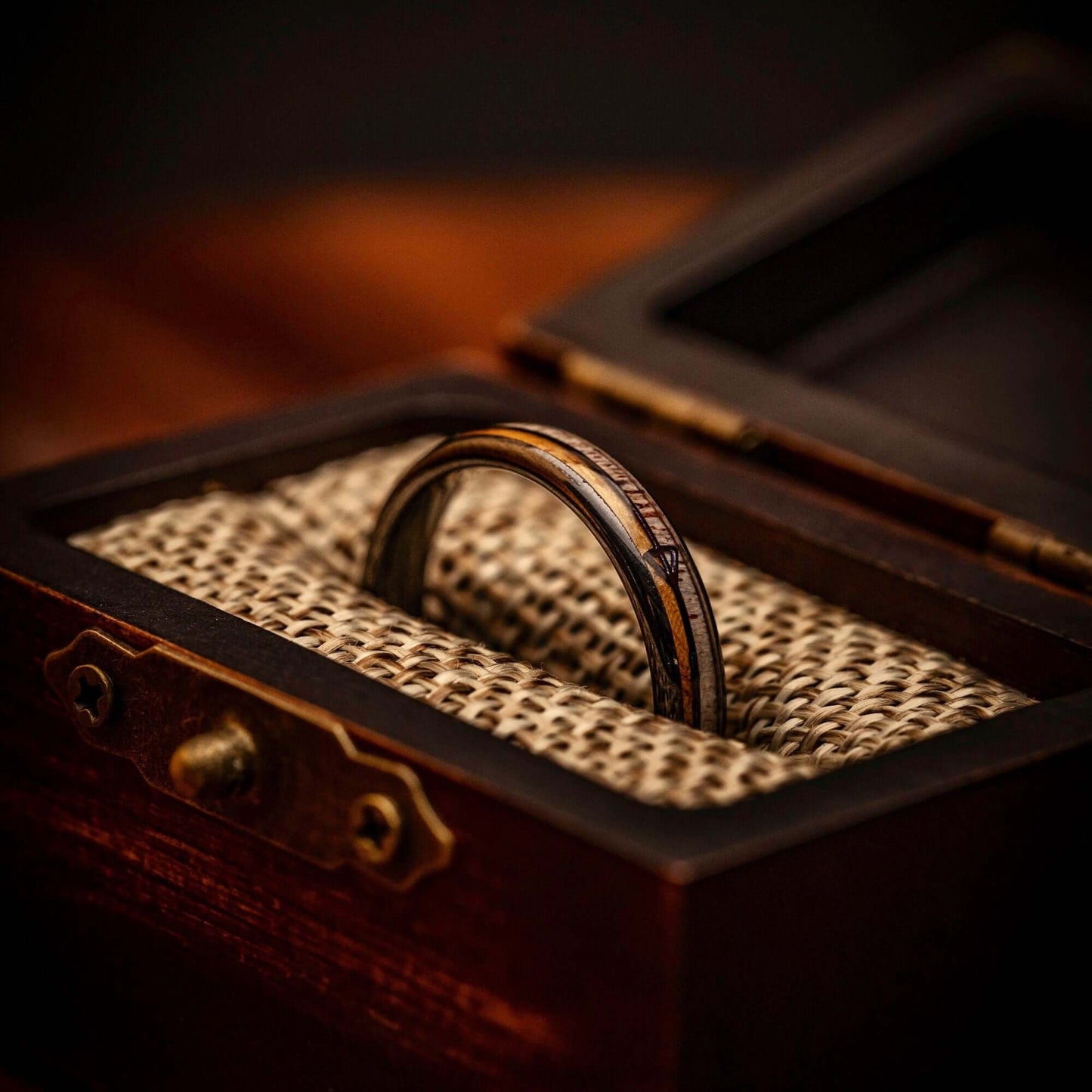 4mm Tungsten Wedding Ring with whiskey barrel wood and deer antler inlay inside a walnut ring box