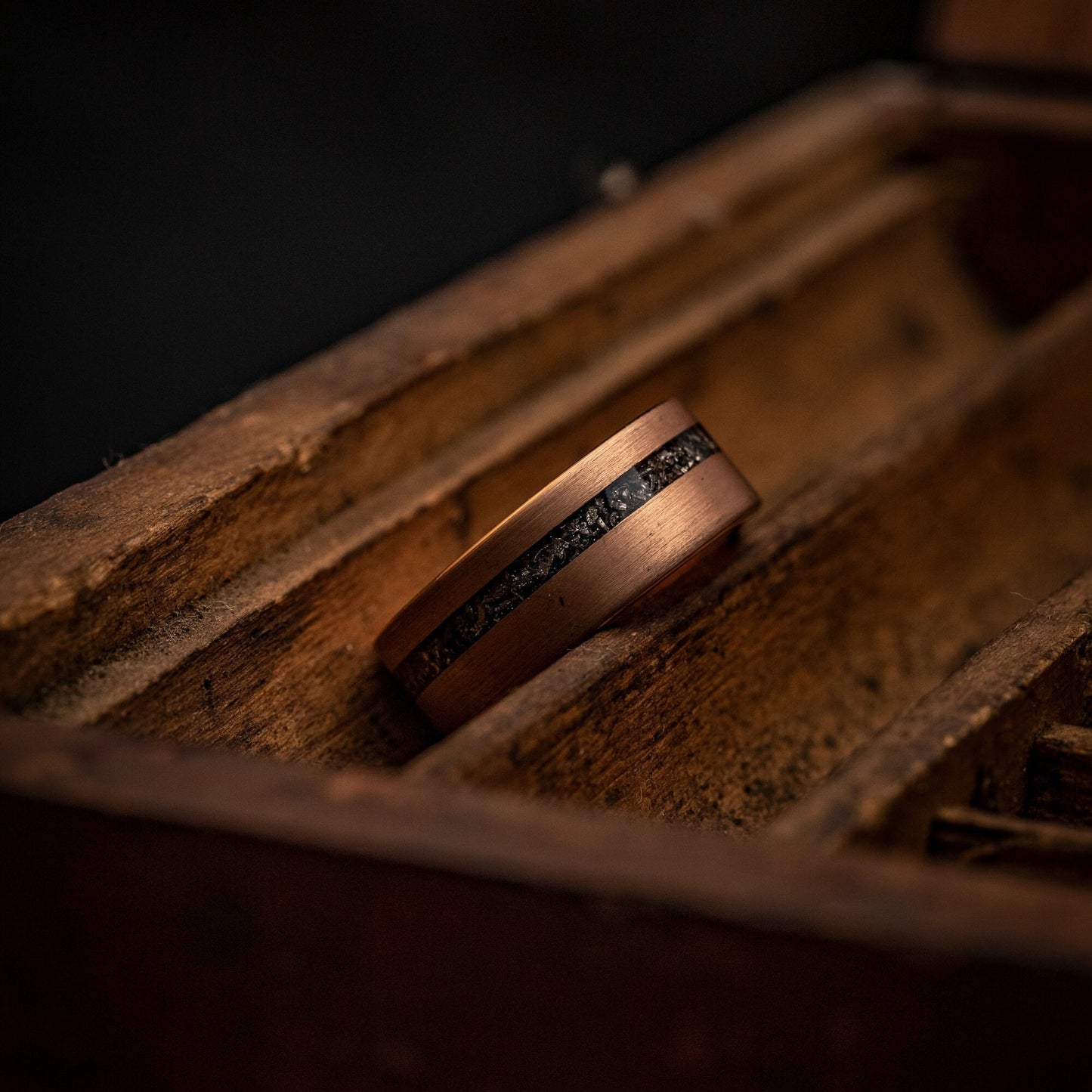 Elegant rose gold wedding band adorned with authentic meteorite inlay.