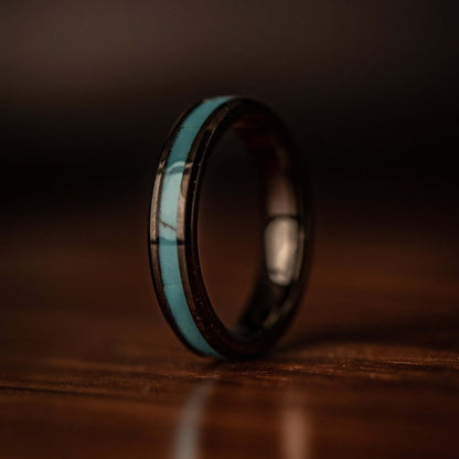 womens wedding ring with turquoise inlay standing on end