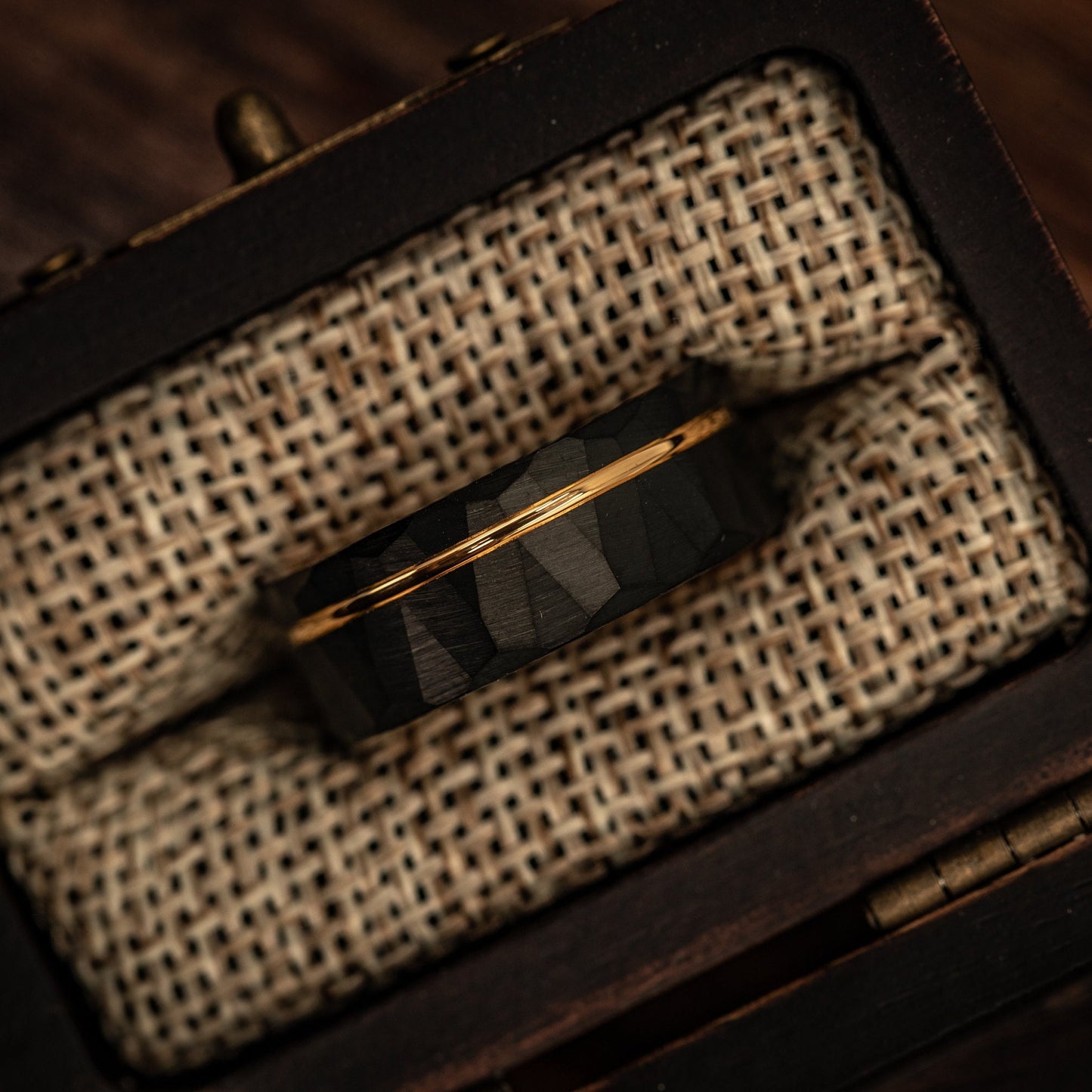 Hammered Black Tungsten Wedding Ring with Polished Rose Gold Inner Band inside walnut ring box